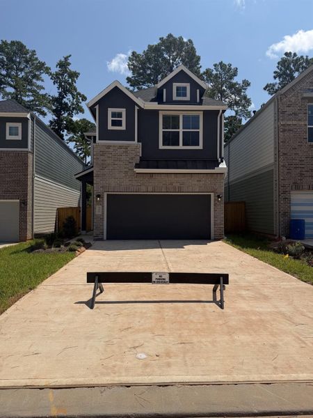 Front exterior of a new home in The Woodland Hills 50', Willis, TX, highlighting curb appeal (Image 1). Front exterior of a new home in The Woodland Hills 50', Willis, TX, highlighting curb appeal (Image 1).