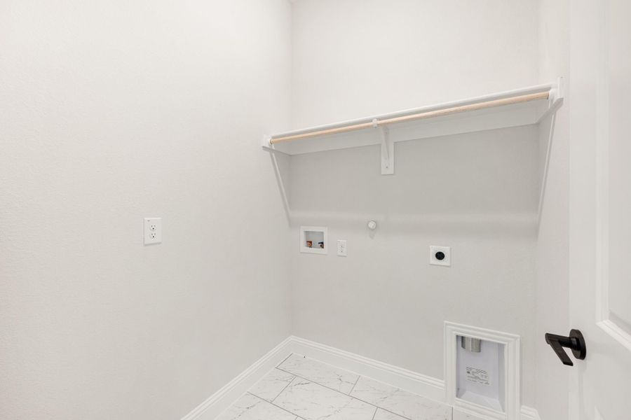 Laundry room with wall shelf, hanging rod, washer hookups, and marble tile floor