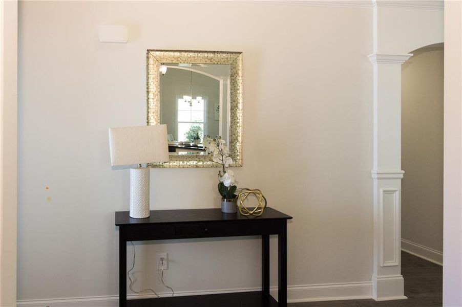 Interior details featuring dark wood-type flooring and decorative columns