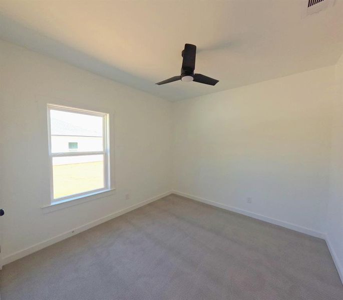Spare room featuring carpet floors and baseboards Spare room featuring carpet floors and baseboards