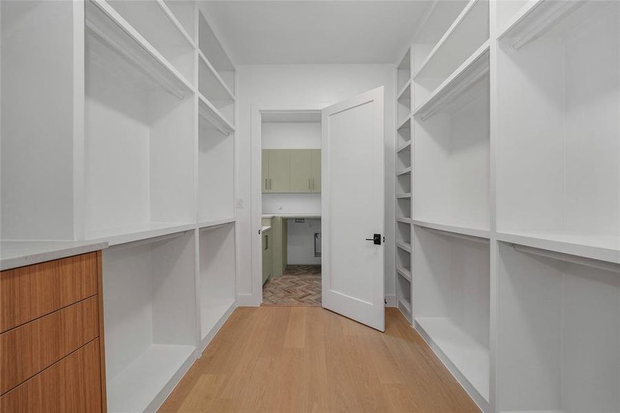 Walk in closet with light wood finished floors Walk in closet with light wood finished floors