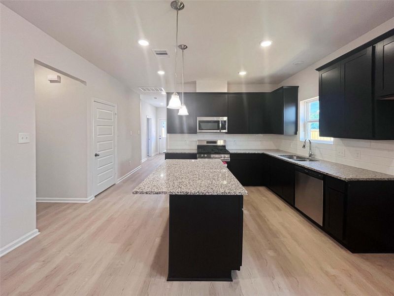 Kitchen from Dining Area. Home under construction. Sample floor plan photo used for illustrative purposes only. Upgrades, selections options, windows and colors may vary.
