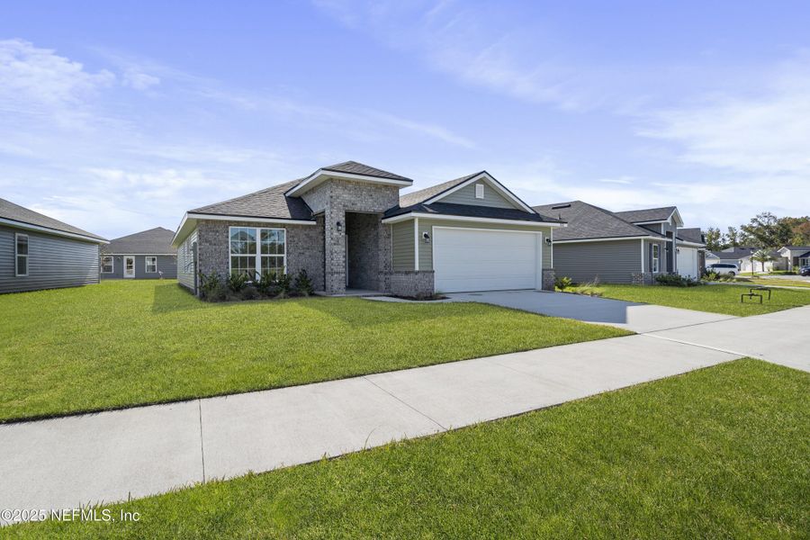 Front exterior of a new home in Summerglen, Jacksonville, FL, highlighting curb appeal (Image 25).