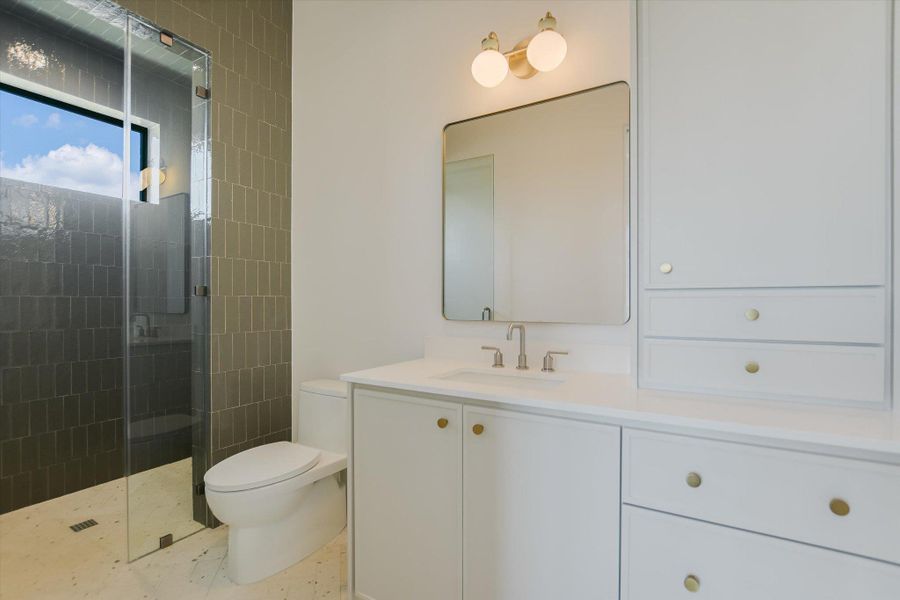 Bathroom featuring vanity and a shower stall