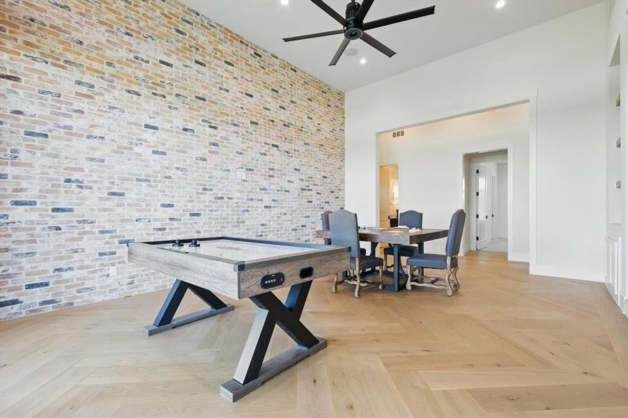 Playroom featuring a ceiling fan, recessed lighting, and a high ceiling Playroom featuring a ceiling fan, recessed lighting, and a high ceiling