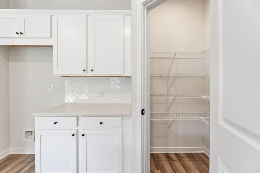 A white kitchen with white cabinets. A white kitchen with white cabinets.