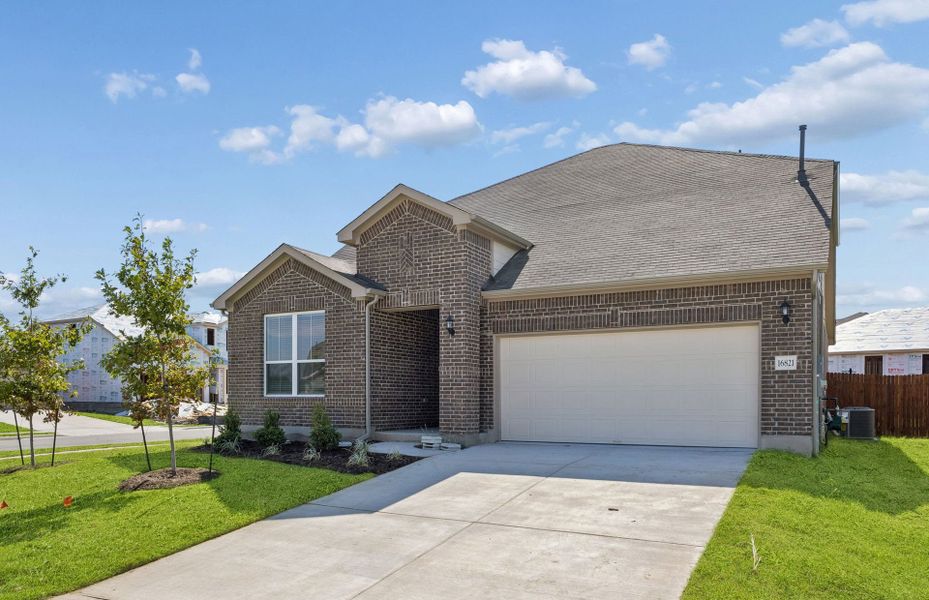 Front exterior of a new home in Lagos, Manor, TX, highlighting curb appeal (Image 22).