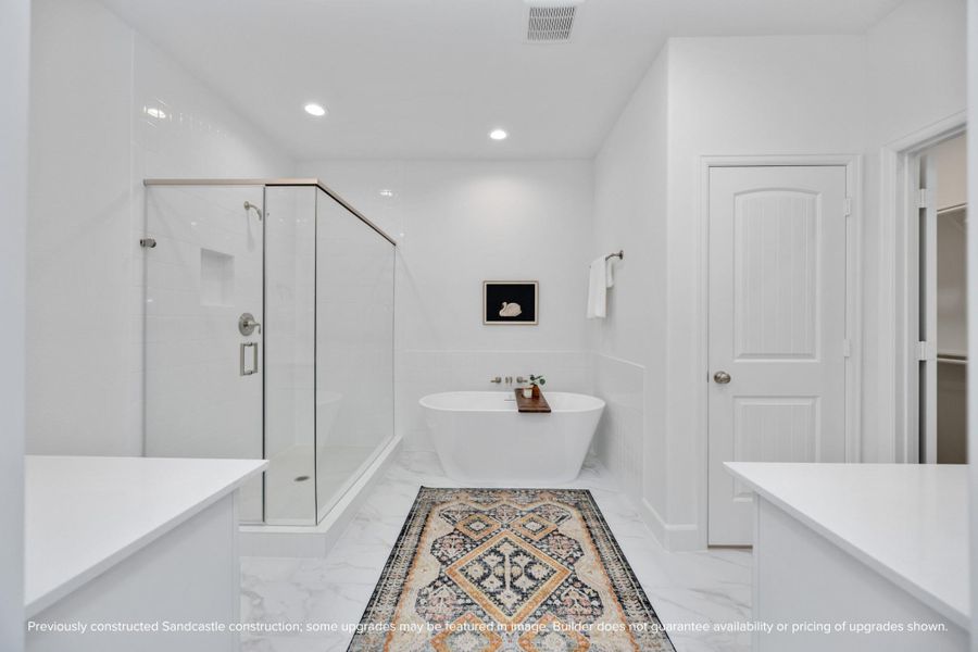 Soak away the stress of the day in your freestanding tub while your favorite playlist echoes off spa-white walls. This luxury en suite was made for unwinding. Soak away the stress of the day in your freestanding tub while your favorite playlist echoes off spa-white walls. This luxury en suite was made for unwinding.