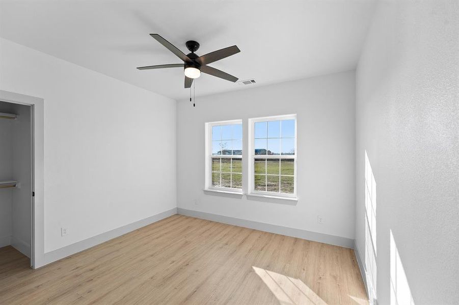 Unfurnished room with light wood-style flooring and a ceiling fan