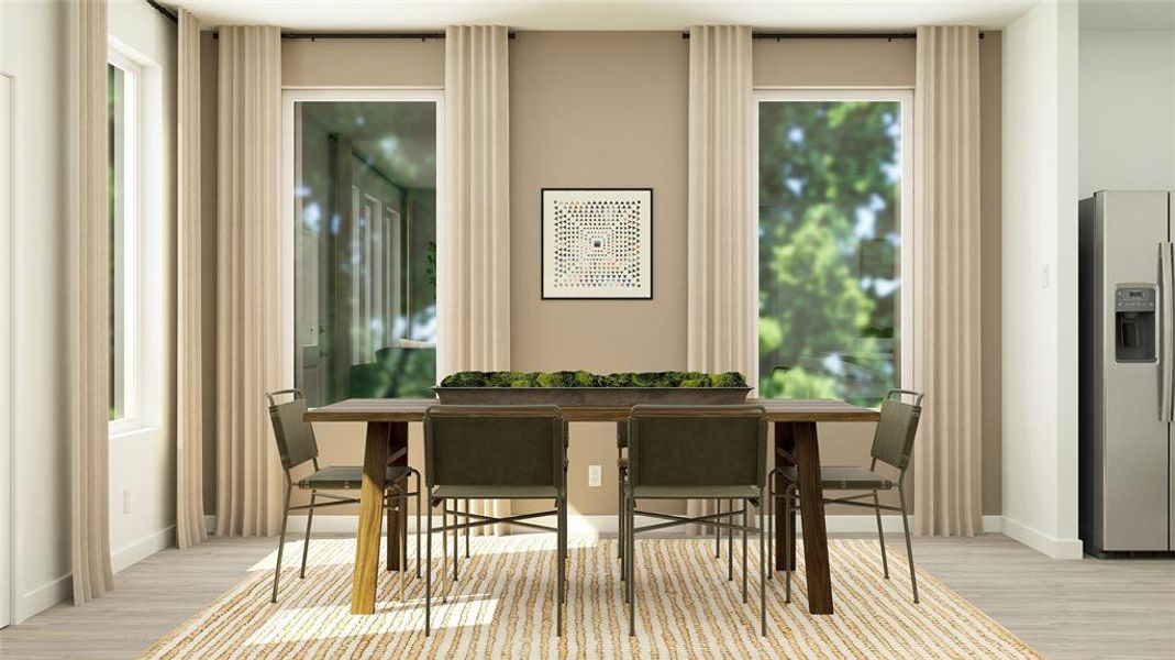Sitting room featuring healthy amount of natural light and light wood-style floors