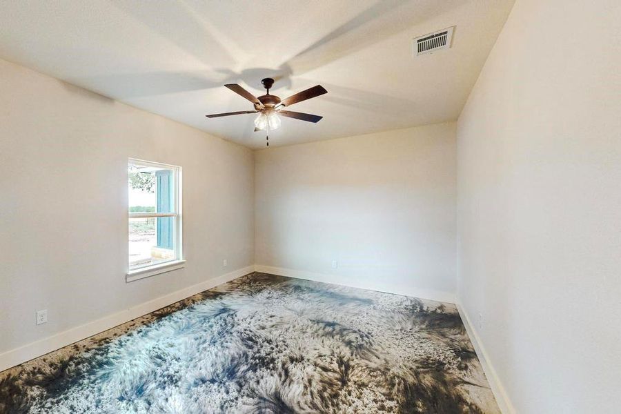 Unfurnished room featuring ceiling fan