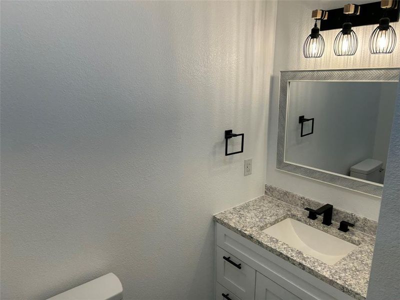 Bathroom with toilet and vanity Bathroom with toilet and vanity