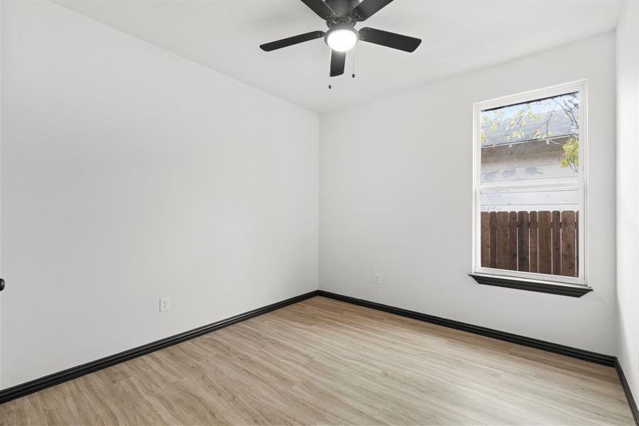 Empty room featuring ceiling fan and light hardwood / wood-style floors