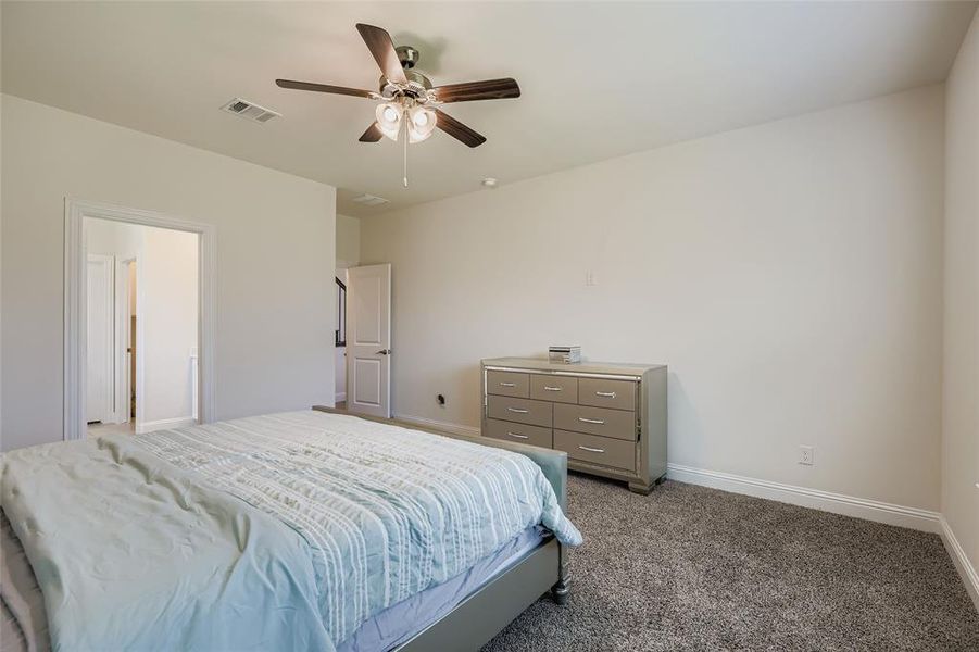 Bedroom featuring carpet and ceiling fan