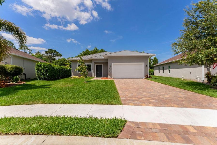 Front exterior of a new home in , Port St. Lucie, FL, highlighting curb appeal (Image 1).