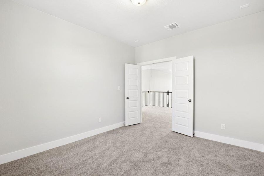 Spare room featuring light carpet and baseboards Spare room featuring light carpet and baseboards