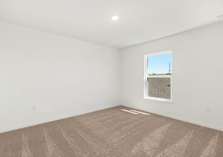 Spacious bedroom with lush carpet