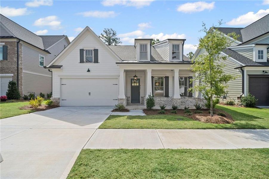 Front exterior of a new home in Lakeside at River Green, Canton, GA, highlighting curb appeal (Image 10). Front exterior of a new home in Lakeside at River Green, Canton, GA, highlighting curb appeal (Image 10).