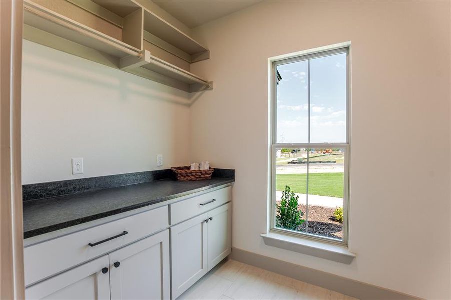 Still in the spacious laundry area, hanging towels bars for the delicates, plenty of space for folding and custom cabinets for extra storage. Still in the spacious laundry area, hanging towels bars for the delicates, plenty of space for folding and custom cabinets for extra storage.