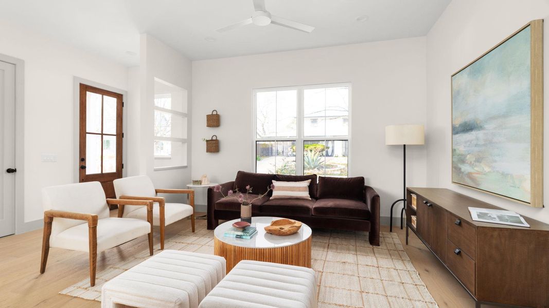 Living area featuring light wood-style floors and ceiling fan