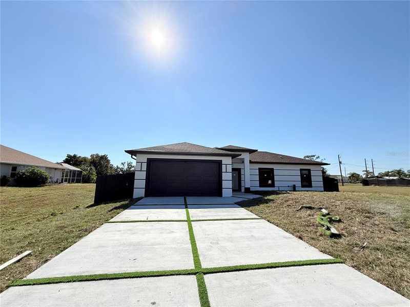 Front exterior of a new home in , Punta Gorda, FL, highlighting curb appeal (Image 1).