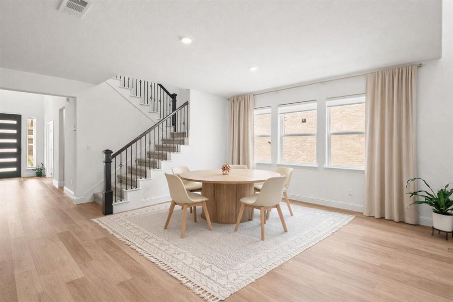 Dining room featuring light wood-style flooring and recessed lighting