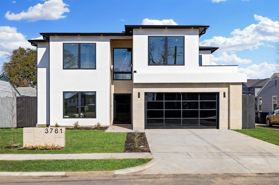 Modern home featuring a garage and a front yard