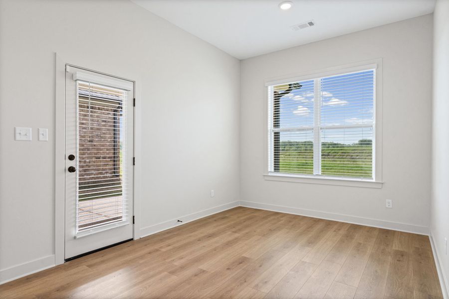 Empty room with light wood-style flooring and baseboards