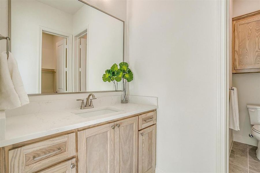 Bathroom featuring tile  flooring, Quartz vanity, and built-ins