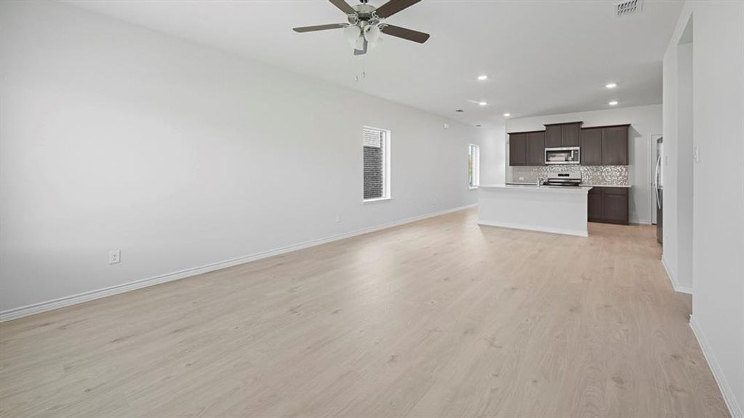 Unfurnished living room with light wood-style floors, recessed lighting, and ceiling fan