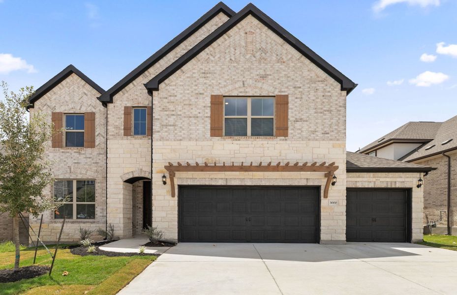 Front exterior of a new home in Bluffview Reserve, Leander, TX, highlighting curb appeal (Image 23).