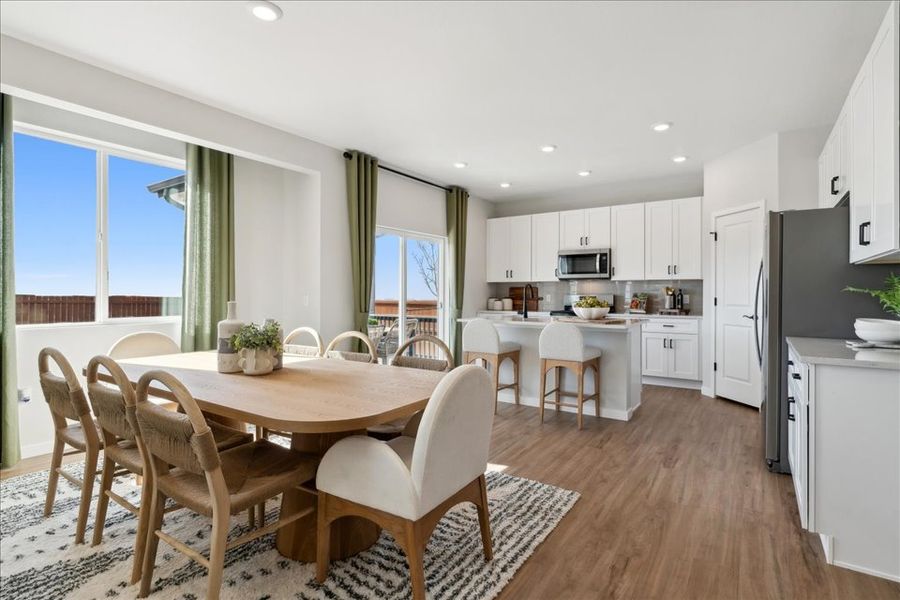 A kitchen with a dining table. A kitchen with a dining table.