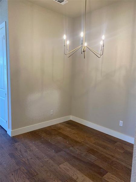 Spare room featuring dark hardwood / wood-style floors