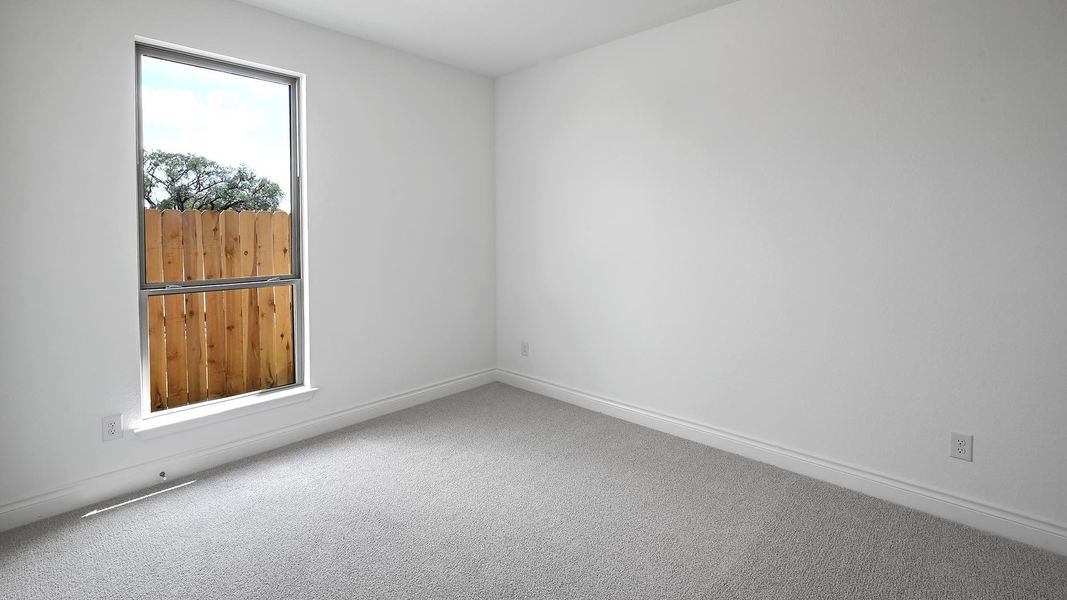 Carpeted spare room with baseboards Carpeted spare room with baseboards