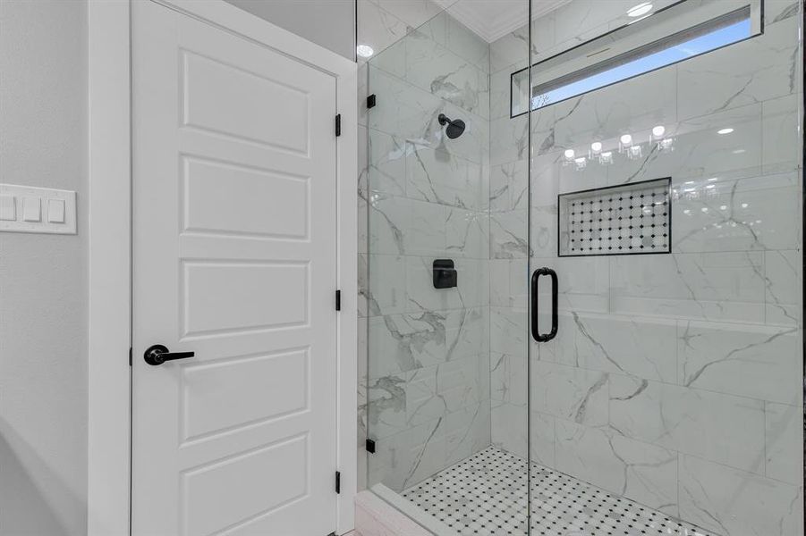 Bathroom with walk in shower and ornamental molding