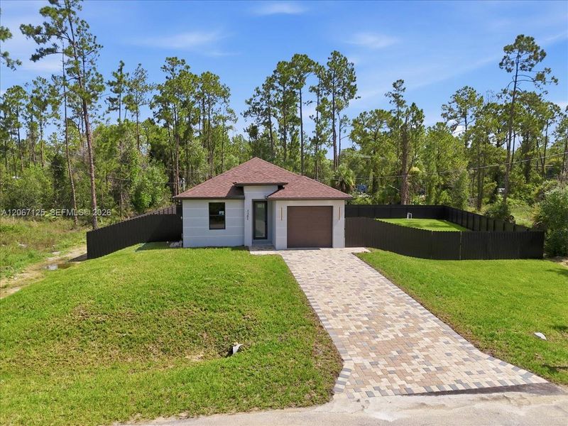 Front exterior of a new home in , Lehigh Acres, FL, highlighting curb appeal (Image 27).