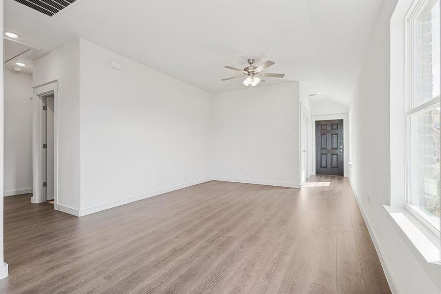 Unfurnished room featuring hardwood / wood-style flooring and ceiling fan