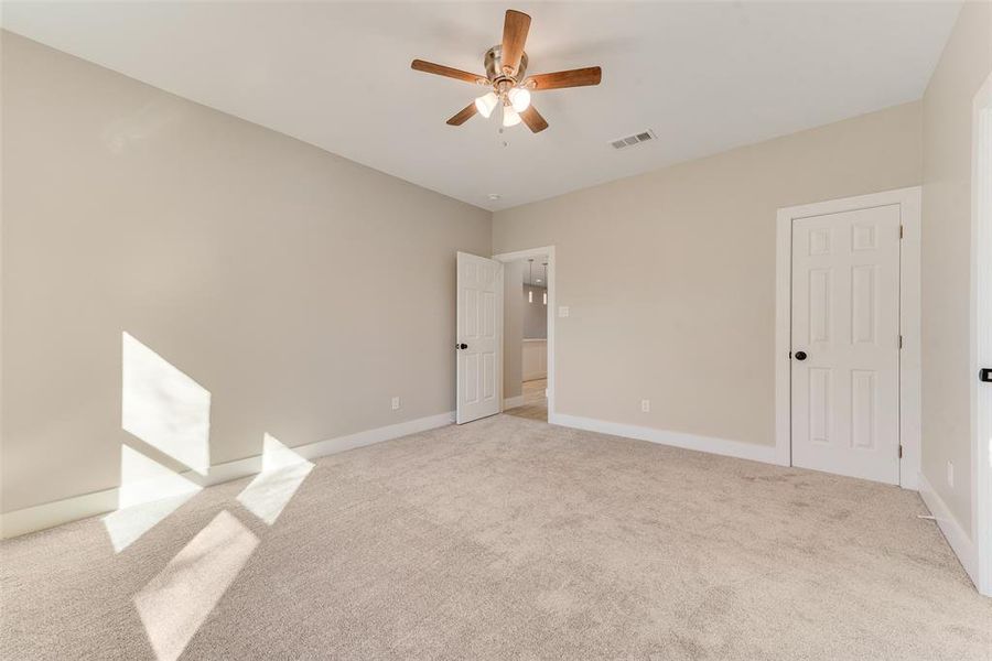 Spare room with ceiling fan and light carpet