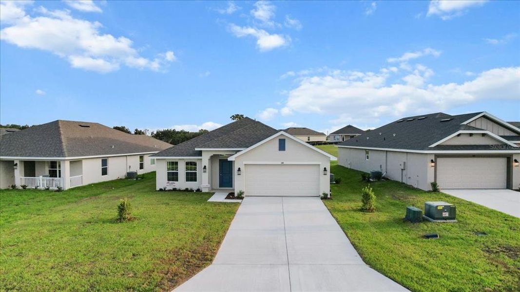 Front exterior of a new home in Twisted Oaks, Beverly Hills, FL, highlighting curb appeal (Image 2).