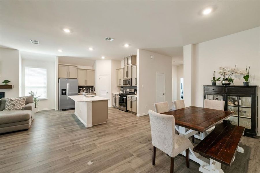 Dining room featuring light wood-style flooring and recessed lighting Dining room featuring light wood-style flooring and recessed lighting