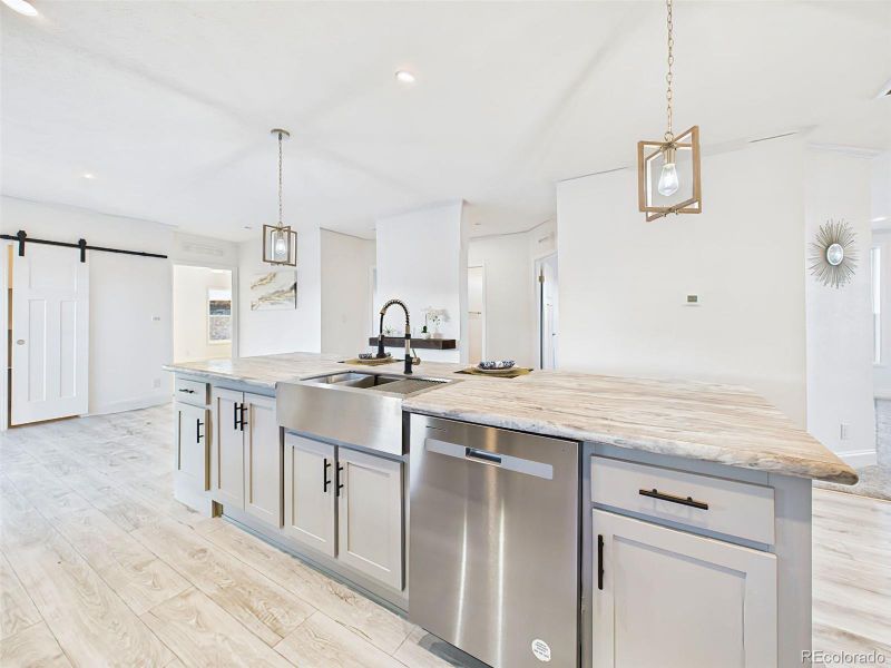 Stainless steel dishwasher in the island and pendent lights for a clean, upscale look. Stainless steel dishwasher in the island and pendent lights for a clean, upscale look.