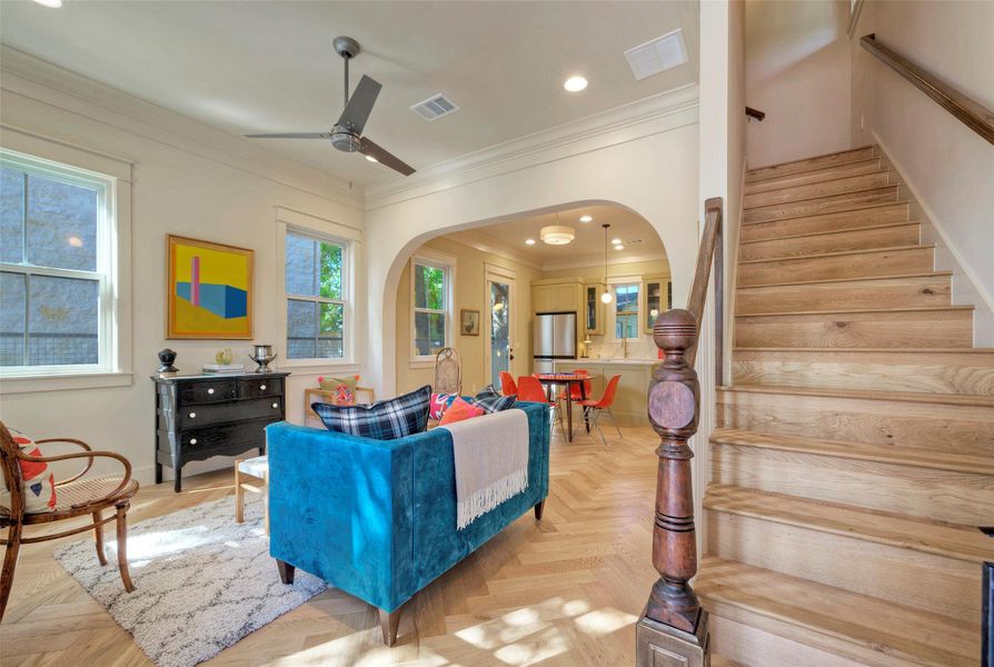 Great craftsmanship shown in the window casings, archway, crown molding, and antique newel post.