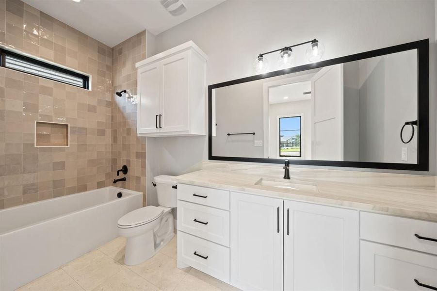 2nd bedroom's ensuite bathroom. Framed mirror and oversized tub.