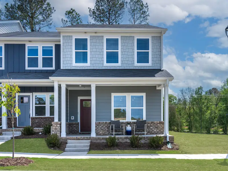Front exterior of a new home in Cadence Meadows Townes, Zebulon, NC, highlighting curb appeal (Image 1). Front exterior of a new home in Cadence Meadows Townes, Zebulon, NC, highlighting curb appeal (Image 1).