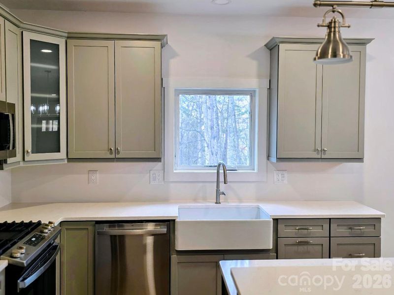 Kitchen with farmhouse sink and GE dishwasher
