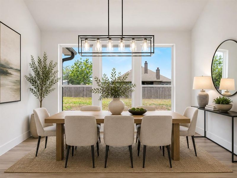 Dining area featuring bright natural light from large windows Dining area featuring bright natural light from large windows