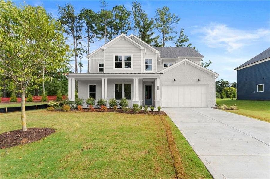 Front exterior of a new home in Hillgrove Preserve, Powder Springs, GA, highlighting curb appeal (Image 1).