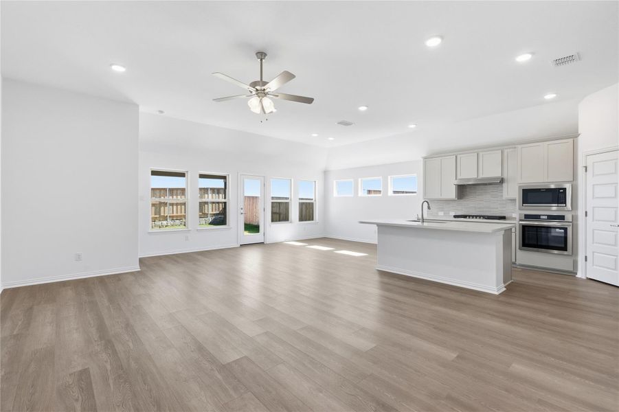 Kitchen with open floor plan, stainless steel appliances, backsplash, recessed lighting, and plenty of natural light