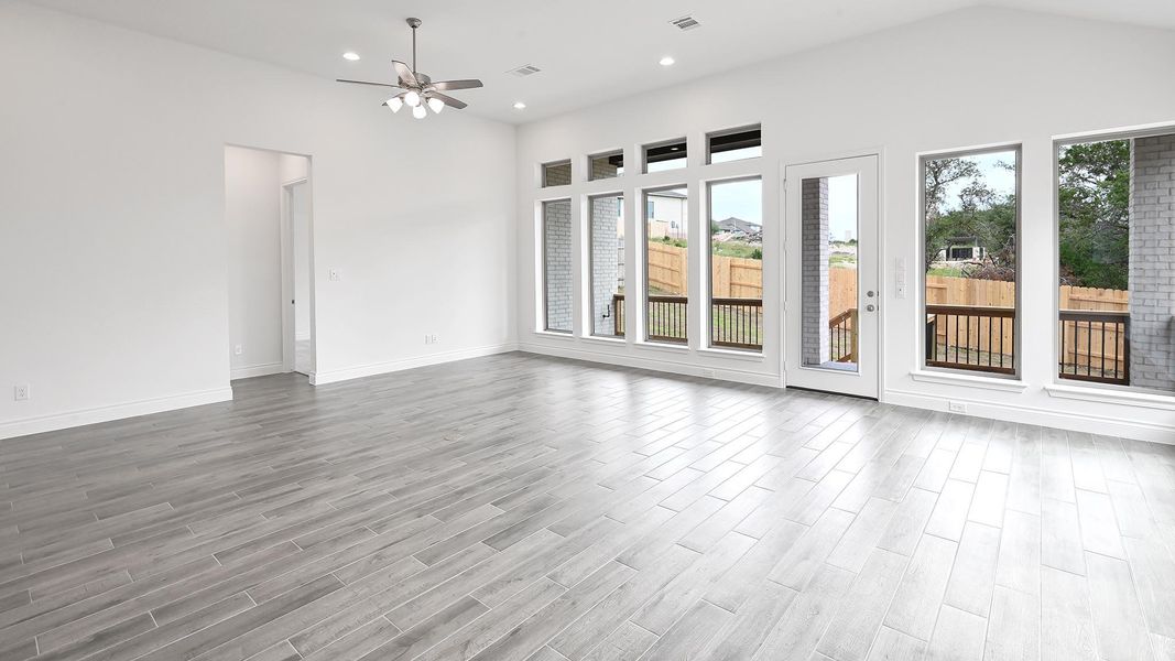 Empty room featuring ceiling fan, wood finished floors, recessed lighting, and baseboards