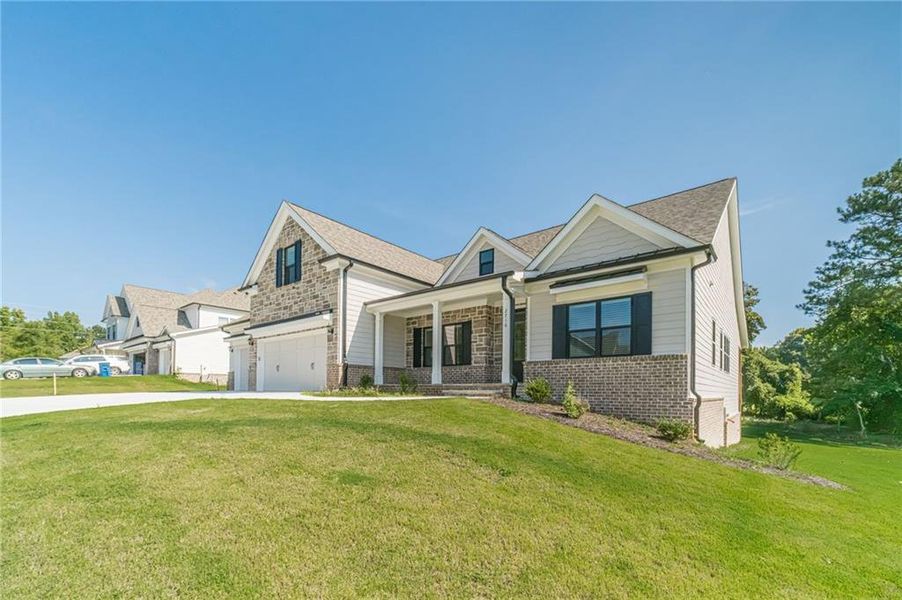 Front exterior of a new home in , Loganville, GA, highlighting curb appeal (Image 2).